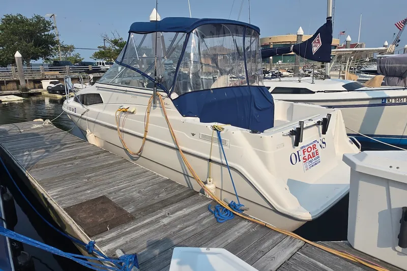 Slide: The Image of 1998 Bayliner 2655 Ciera boat docked, for sale sign visible. - 23