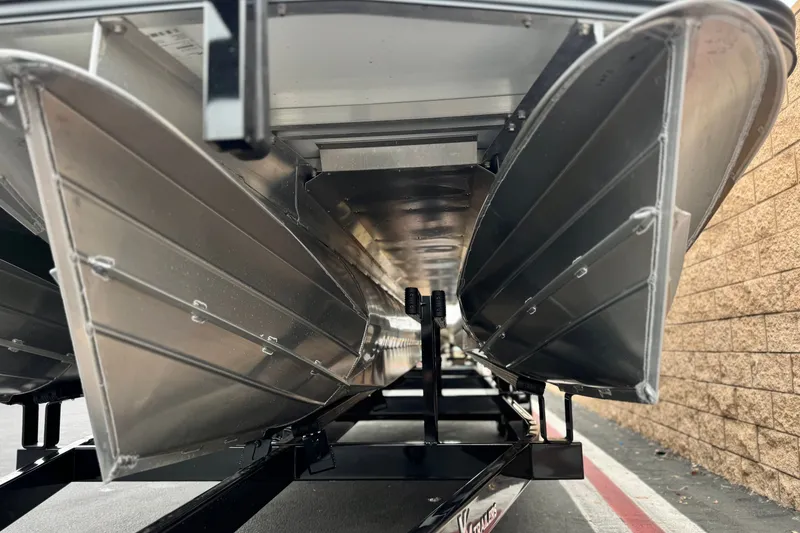 Slide: The Image of Underneath view of a 2025 Manitou EXPLORE 24 pontoon boat on a trailer. - 4