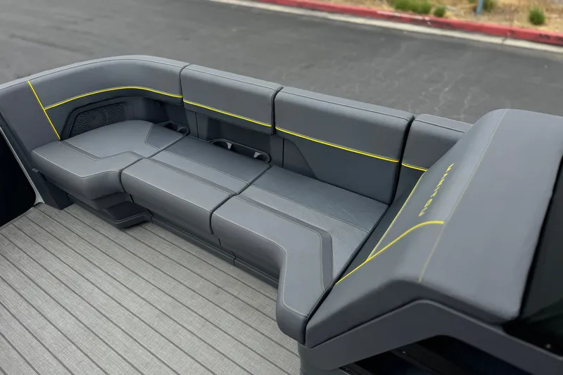 Slide: The Image of Luxurious seating on 2025 Manitou EXPLORE 24 boat, featuring sleek gray upholstery with yellow accents. - 12