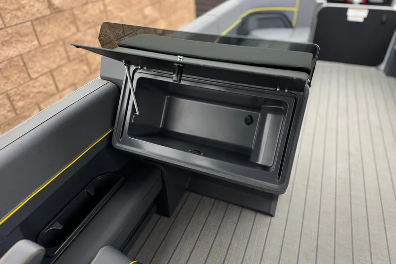 Slide: The Image of Open storage compartment on 2025 Manitou EXPLORE 24 boat, featuring sleek interior design. - 23