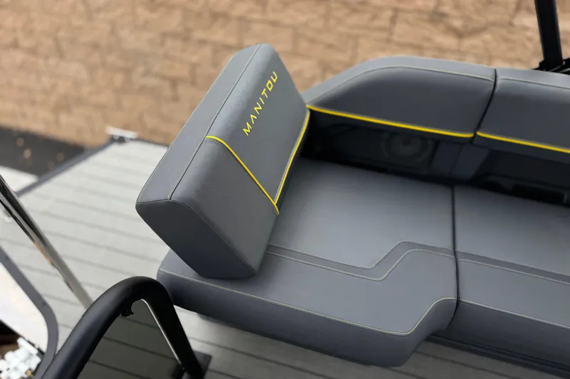 Slide: The Image of Gray seating with yellow accents on a 2025 Manitou EXPLORE 24 boat. - 19