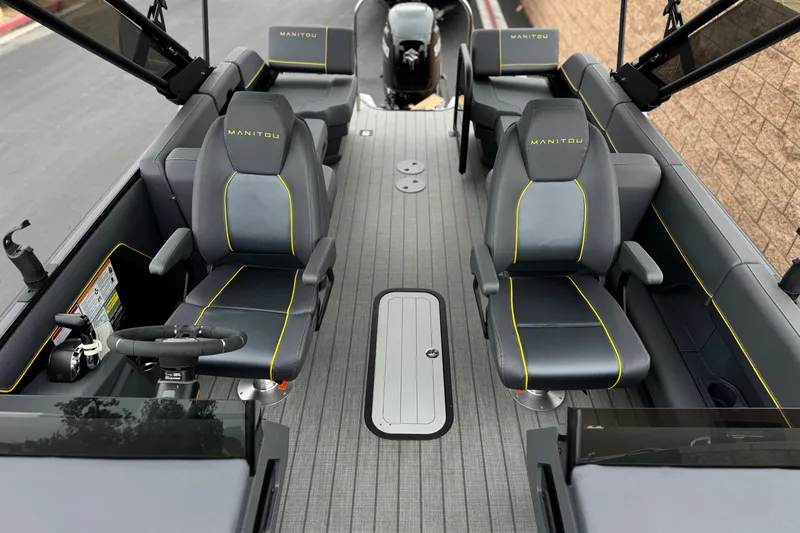 Slide: The Image of 2025 Manitou EXPLORE 24 boat interior with sleek seating and modern design. - 13