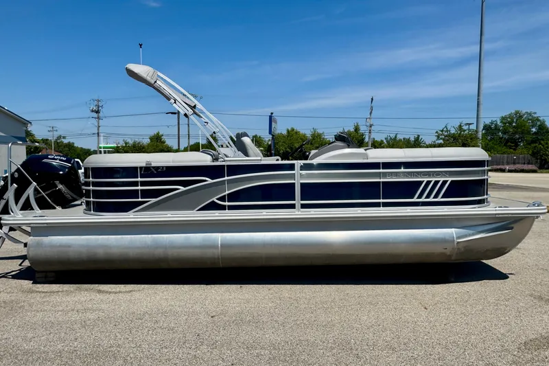 Slide: The Image of 2023 Bennington 23 LX STERN RADIUS pontoon boat on display outdoors. - 3