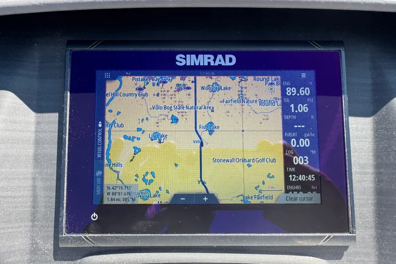 Slide: The Image of Simrad navigation display on 2023 Bennington 23 LX STERN RADIUS, showing map and engine data. - 16
