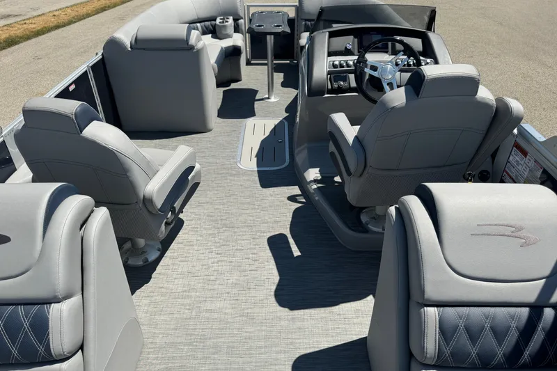 Slide: The Image of 2023 Bennington 23 LX STERN RADIUS pontoon boat interior with luxurious seating and helm. - 20