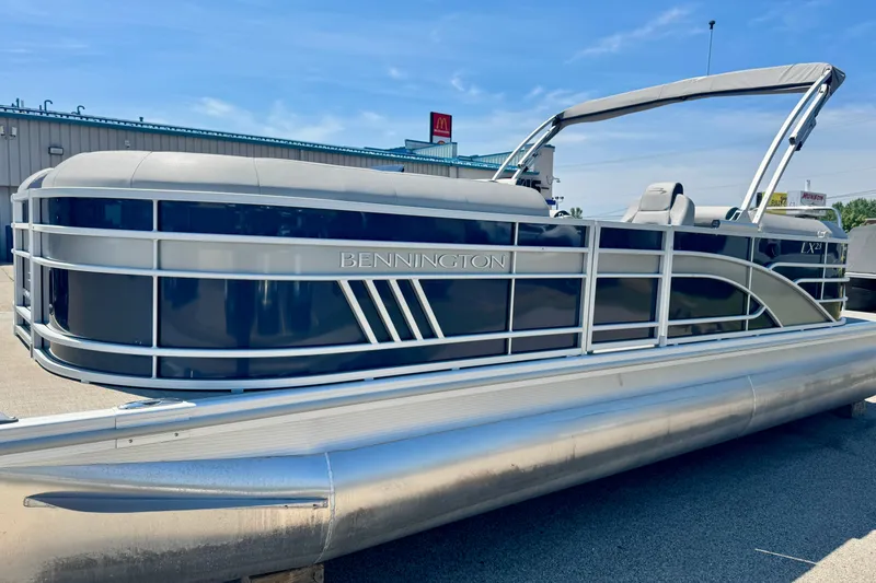 The Image of 2023 Bennington 23 LX STERN RADIUS pontoon boat on display outdoors. - 0