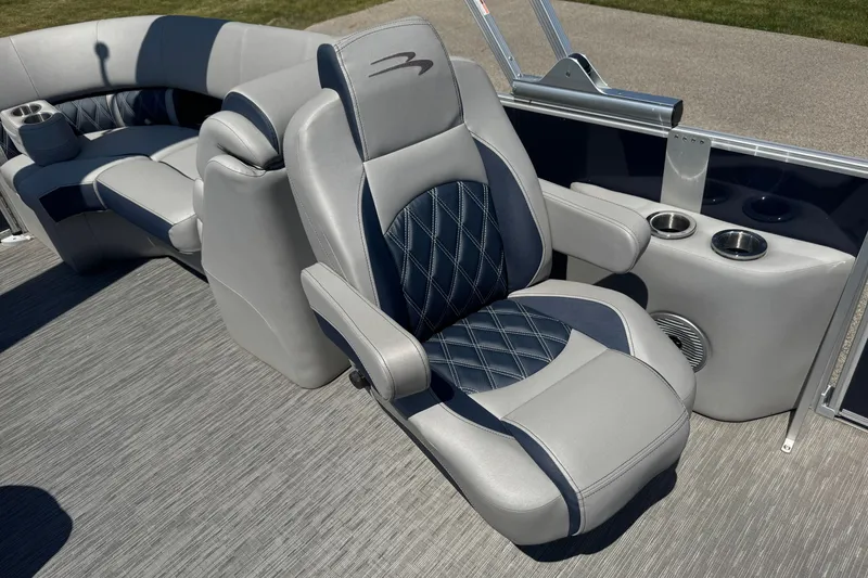 Slide: The Image of 2023 Bennington 23 LX STERN RADIUS boat interior with luxurious seating and cup holders. - 21