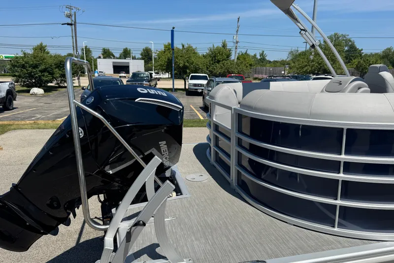 Slide: The Image of 2023 Bennington 23 LX STERN RADIUS pontoon boat with Mercury outboard motor in parking lot. - 29