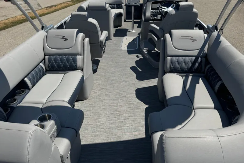 Slide: The Image of 2023 Bennington 23 LX STERN RADIUS pontoon boat interior with luxurious seating and modern design. - 22