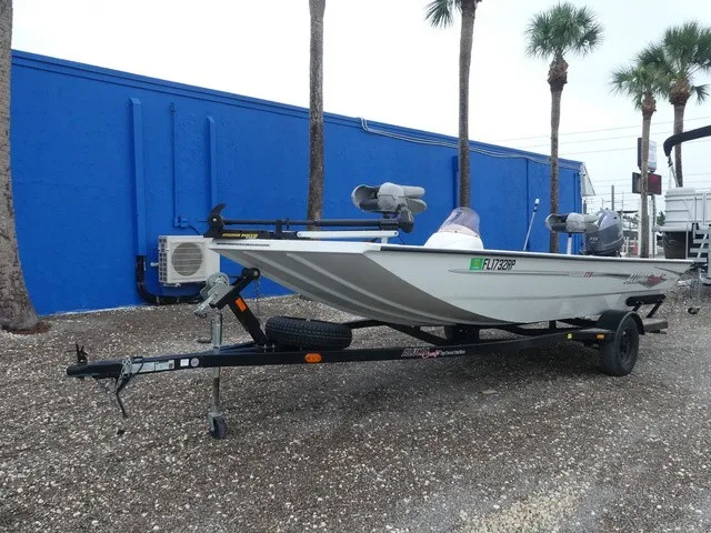 Slide: The Image of A 2018 Alumacraft 175 PROWLER on a trailer, parked in front of a blue wall. - 2