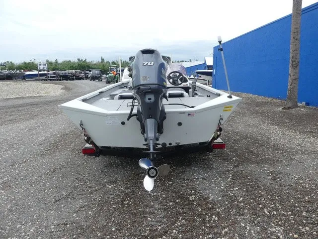 Slide: The Image of The image shows a 2018 Alumacraft 175 PROWLER boat with an outboard motor. - 6