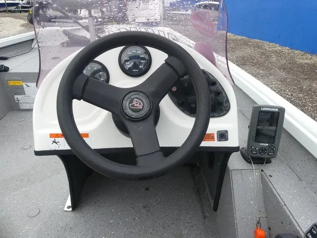 Slide: The Image of The image shows the helm of a 2018 Alumacraft 175 PROWLER boat with instruments and a fish finder. - 14