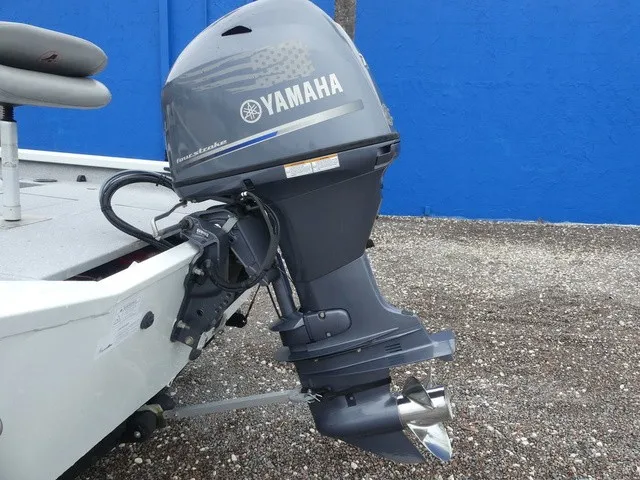 Slide: The Image of A 2018 Alumacraft 175 PROWLER with a Yamaha outboard motor, parked on a gravel surface. - 11