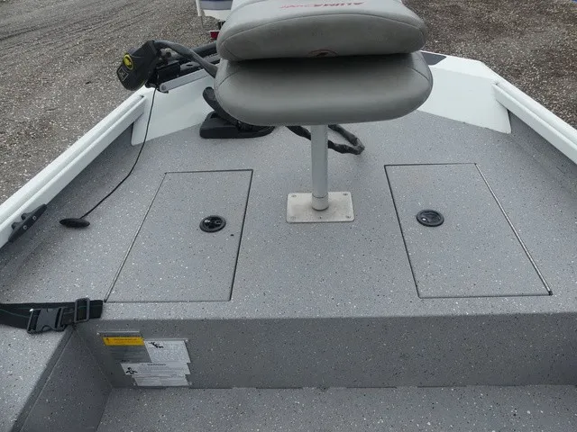 Slide: The Image of The image shows the deck of a 2018 Alumacraft 175 PROWLER boat with a seat and storage compartments. - 16