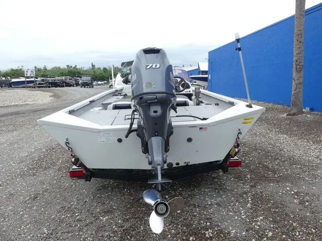 Slide: The Image of A 2018 Alumacraft 175 PROWLER with an outboard motor, parked on a trailer. - 7