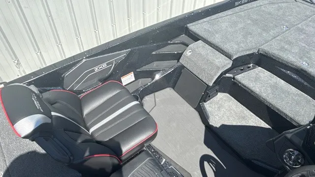 Slide: The Image of The image shows the cockpit of a 2027 Skeeter ZXE21 boat with padded seating and gray carpeting. - 15