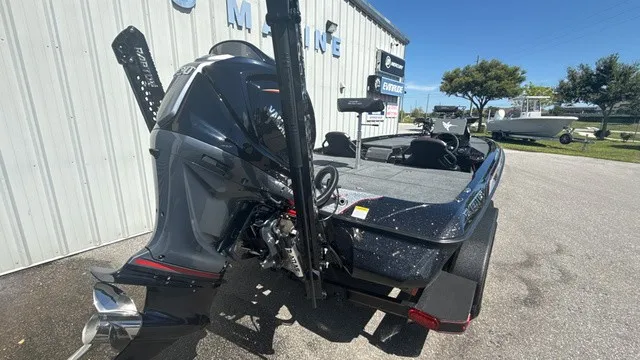 Slide: The Image of A 2027 Skeeter ZXE21 is parked outside. The outboard motor is prominently visible. - 3