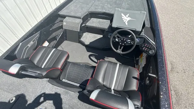Slide: The Image of The image shows the cockpit of a 2027 Skeeter ZXE21 boat with two black seats. - 14