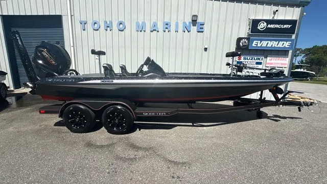 The Image of A black Skeeter ZXE21 boat from 2027 is on a trailer in front of a building. - 1