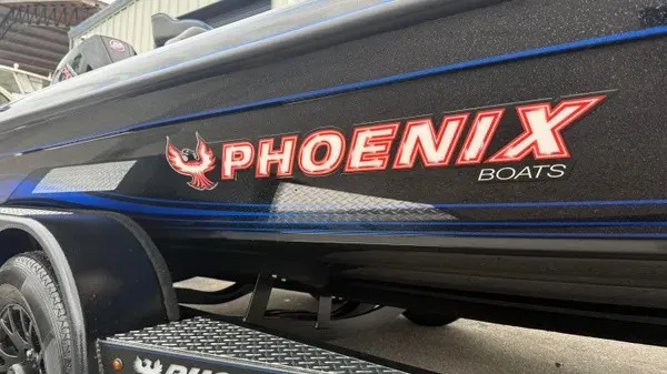 Slide: The Image of Side view of a 2027 Phoenix 921 Elite X boat with prominent logo. - 2