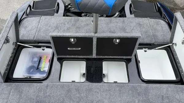 Slide: The Image of The image shows the deck of a 2027 Phoenix 921 Elite X boat with multiple storage compartments. - 18