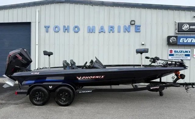 The Image of A 2027 Phoenix 921 Elite X boat on a trailer in front of a building labeled "TOHO MARINE." - 1