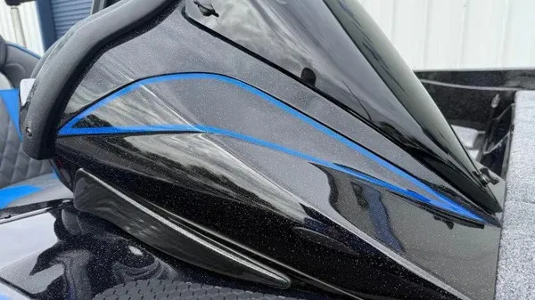 Slide: The Image of Close-up of a glossy black boat part with blue accents, likely part of the Phoenix 921 Elite X. - 3