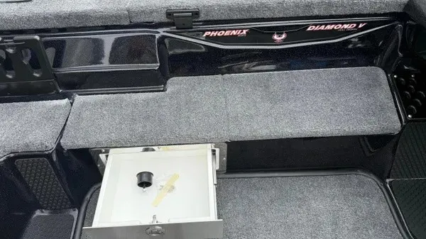 Slide: The Image of Interior view of a 2027 Phoenix 921 Elite X with gray carpeting and storage compartment. - 14