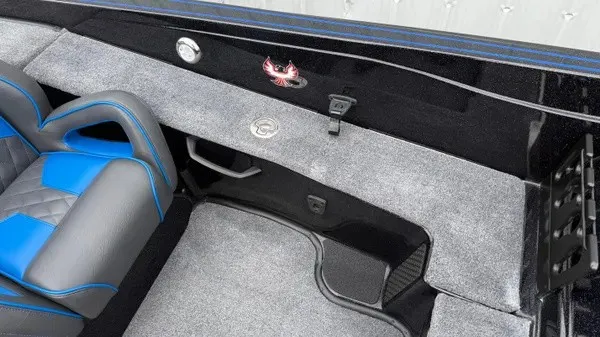 Slide: The Image of The image shows the interior of a Phoenix 921 Elite X boat with gray carpet and blue accents. - 15
