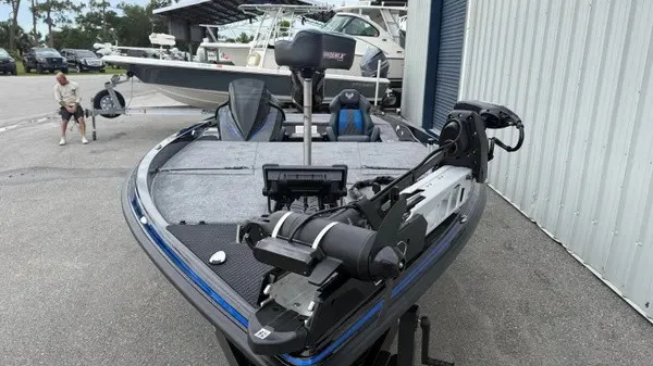 Slide: The Image of A modern fishing boat with a gray deck and blue accents, equipped with an electric motor. - 10