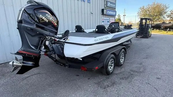 Slide: The Image of A white Skeeter ZXR21 SE boat from 2026 on a trailer. It features a Yamaha outboard motor. - 2