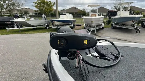 Slide: The Image of A 2026 Skeeter ZXR21 SE with a modern control system on the deck. Several boats on trailers are visible in the background. - 12