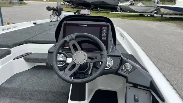 Slide: The Image of The image shows the cockpit of a 2026 Skeeter ZXR21 SE boat with a modern helm. - 9