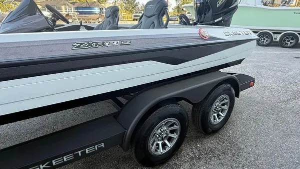 Slide: The Image of The image shows a Skeeter ZXR21 SE boat on a trailer. It features a sleek design. - 3