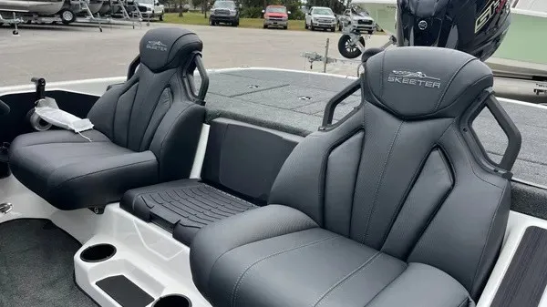 Slide: The Image of The image shows the seats of a 2026 Skeeter ZXR21 SE boat. The seats are padded and feature a modern design. - 8