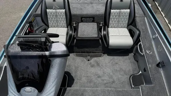 Slide: The Image of The image shows the cockpit of a 2027 Phoenix 721 ZXL boat with two cushioned seats and a central table. - 20