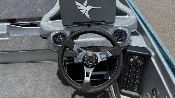 Slide: The Image of The image shows the cockpit of a Phoenix 721 ZXL boat with a modern steering wheel and instruments. - 23