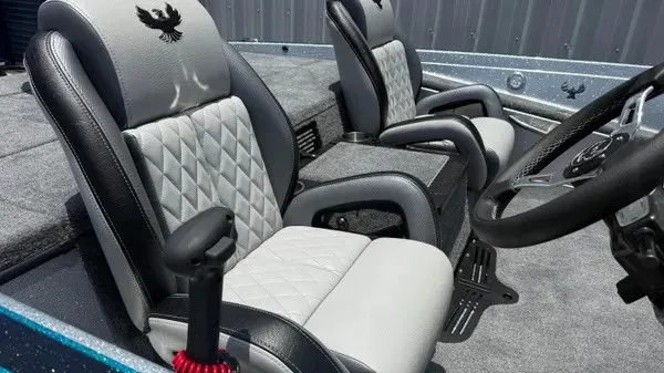 Slide: The Image of Interior of a 2027 Phoenix 721 ZXL with two cushioned seats and a steering wheel. - 16