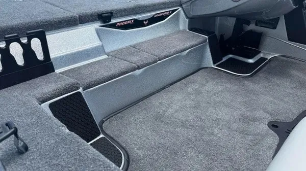Slide: The Image of Interior view of a Phoenix 721 ZXL boat with gray carpeting and storage compartments. - 11