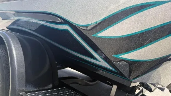 Slide: The Image of Close-up of a Phoenix 721 ZXL boat hull with blue and black design. - 8