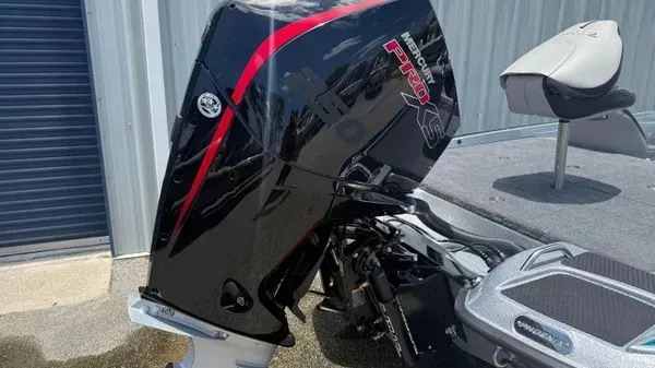 Slide: The Image of A powerful outboard motor is attached to a modern boat sitting on a trailer. - 5