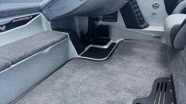 Slide: The Image of Interior view of a Phoenix 721 ZXL boat with gray carpeting and a steering console. - 10