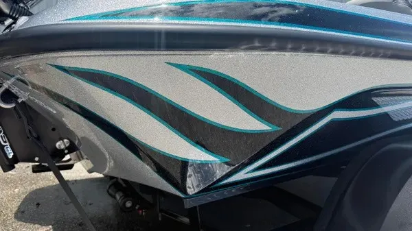 Slide: The Image of Close-up of a Phoenix 721 ZXL boat hull with blue and black stripes. - 3
