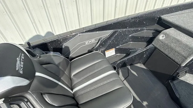 Slide: The Image of The image shows the interior of a 2027 Skeeter ZXE20 boat with black leather seats. - 12