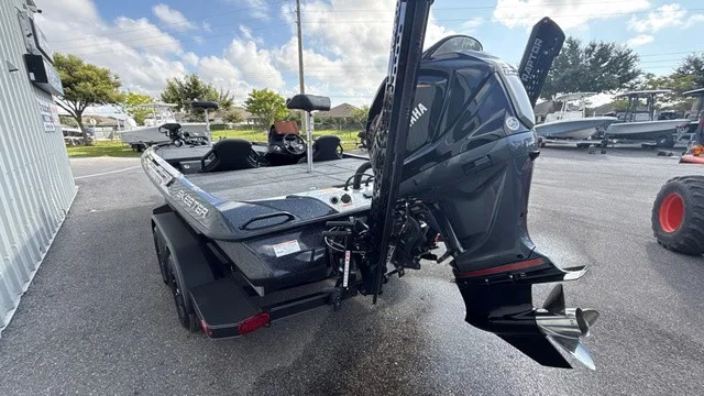 Slide: The Image of Skeeter ZXE20 2027: Sleek design, powerful outboard motor, parked on a trailer outdoors. - 4