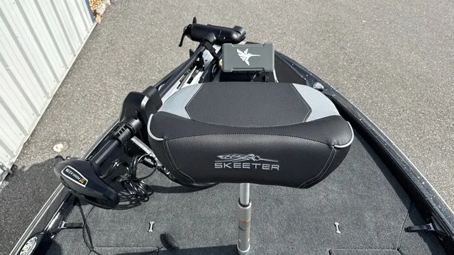 Slide: The Image of Skeeter ZXE20 2027: Front deck with padded seat and controls, parked on a trailer. - 13