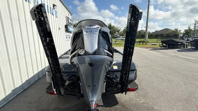 Slide: The Image of A gray Skeeter ZXE20 boat from 2027 with a powerful outboard motor, parked on a trailer. - 3