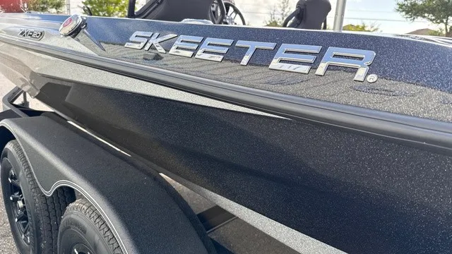 Slide: The Image of Close-up of a 2027 Skeeter ZXE20 boat on a trailer, featuring a shiny black hull. - 6