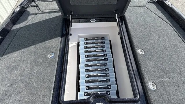 Slide: The Image of The image shows the storage compartment of a Skeeter ZXE20 boat with multiple batteries. - 14
