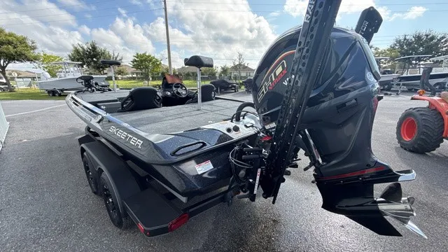Slide: The Image of A modern 2027 Skeeter ZXE20 with a powerful outboard motor, parked on a trailer. - 5
